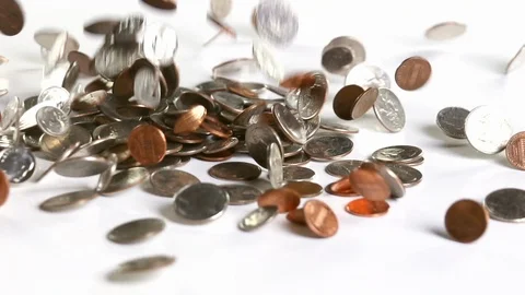 US coins falling onto a white surface in slow motion Stockbeeldmateriaal 110890421