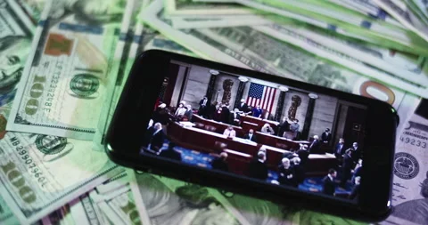 U.s. Congress Image on iphone surrounded by $100 Bills. Stock Footage 169007152