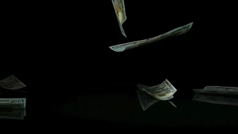 US currency bank notes dropping onto a dark mirror surface in slow motion Stock Footage 326628220