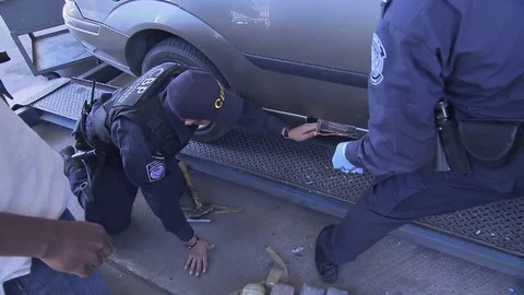 The U.S. Customs and Border Protection discovers drugs hidden in vehicles at the Stock Footage 74813602