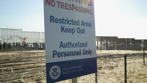 U.S. Customs and Border Protection "No Trespassing" sign, Mexico/U.S. border. Stock Footage 98950424