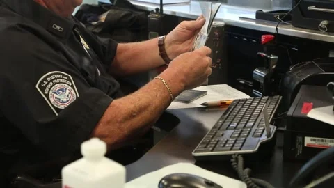 U.S. Customs and Border Protection Officer checking passports at airport Video stock 295113347