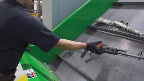 U.S. Customs and Border Protection staff load confiscated firearms onto conveyor Stock Footage 333680824