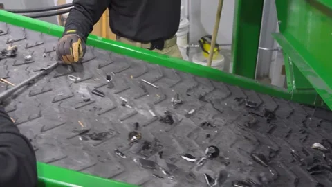 U.S. Customs and Border Protection personnel sort destroyed firearms on conveyor Stock Footage 333680886