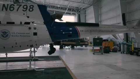 U.S Customs Border Protection Airbus AS350 A-star being towed out of hangar Stock Footage 299566252
