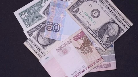 US dollar and Russian ruble bills falling on a black background. Exchange r.. Stock Footage 318557639