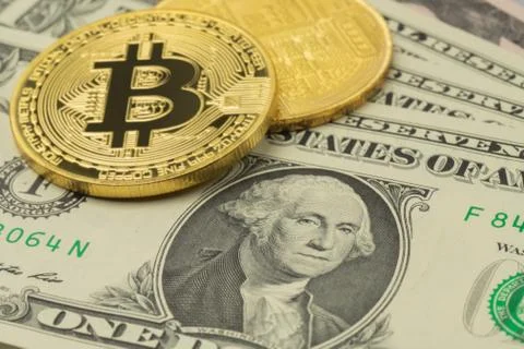 US Dollar banknotes and two Bitcoin coins Stock Photos