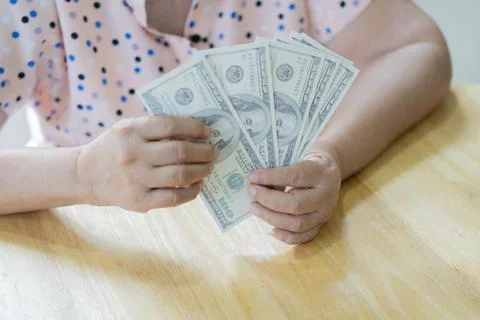 US dollar banknotes in hands of elderly woman. Pension payments ,retirement.. Stock Photos