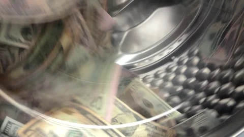 US dollar banknotes inside spinning washing machine drum Stock Footage 340141346