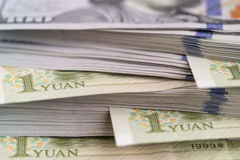 US dollar banknotes stack with Chinese yuan bills close up Stock Photos