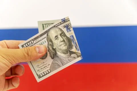 US dollar, bill on the background of the flag of the Russia Federation. con.. Stock Photos