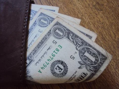 US dollar bills inside a leather wallet. Business financial concept with cash Stock Photos