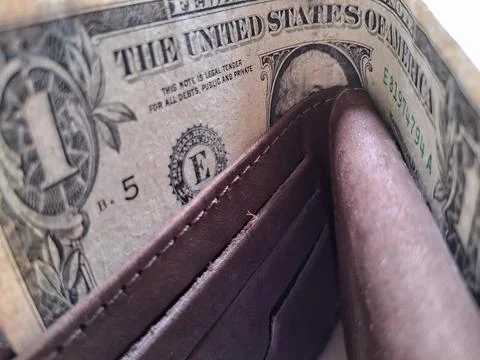 US dollar bills inside a leather wallet. Business and financial concept imagery. Stock Photos
