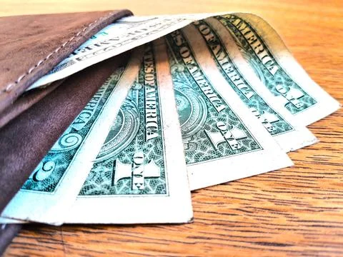 US dollar bills inside a leather wallet. Business and financial concept image. Stock Photos