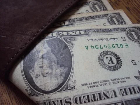 US dollar bills inside a leather wallet. Financial transaction and money Stock Photos