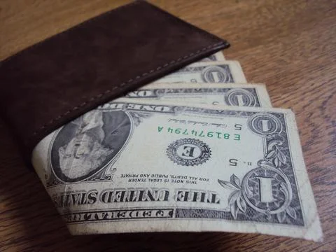 US dollar bills inside a leather wallet. Business and financial concept image. Stock Photos