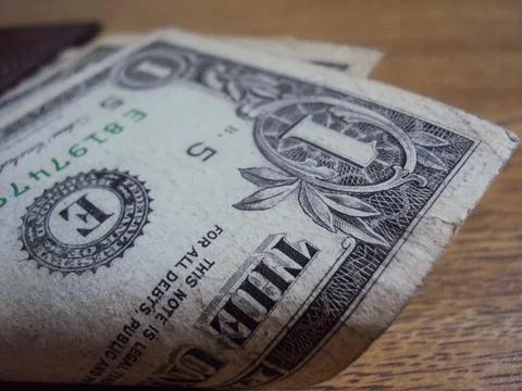 US dollar bills inside a leather wallet. Financial transaction and cash Stock Photos