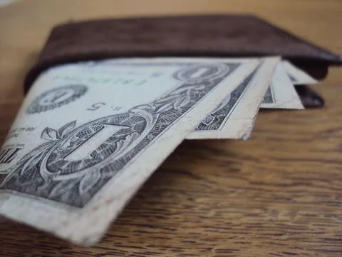 US dollar bills inside a leather wallet. Financial transaction and money Stock Photos
