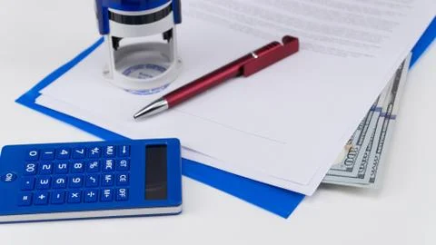 US dollar under documents Stock Photos