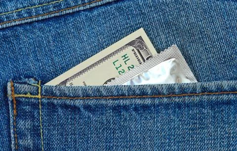 U.s. dollars and condom in the back jeans pocket Stock Photos