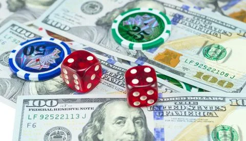 U.S. dollars and dice Stock Photos