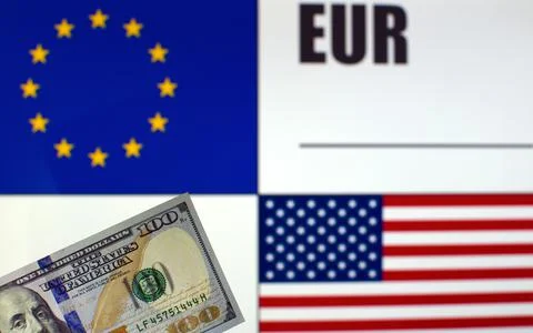 US dollars banknote on blurred background of EU and US flags Stock Photos
