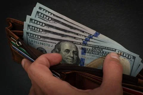 US dollars in leather wallet Stock Photos