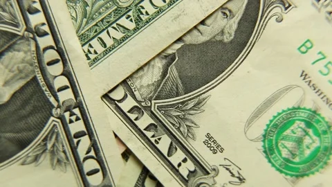 US dollars paper bills rotate. Top view. Close-up of the inscription ONE. Stock Footage 167914495
