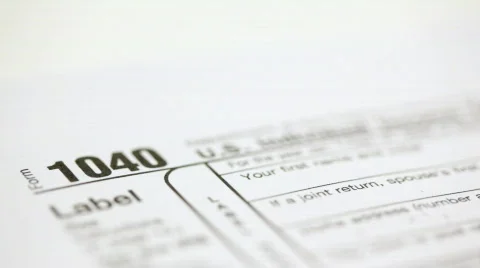 U.S. dollars stacked next to U.S. tax form Stock Footage 306125