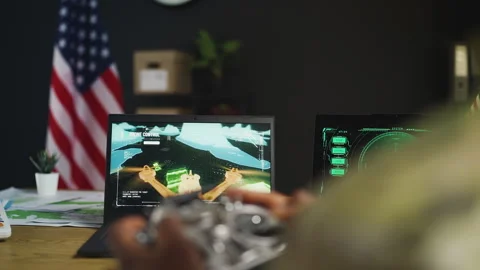 U.S. drone operator trains with FPV headset and remote controller in office Stock Footage 342149533