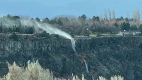 US: Extreme winds reverse Shoshone Falls flow in Twin Falls, Idaho, USA Stock Footage 324384147