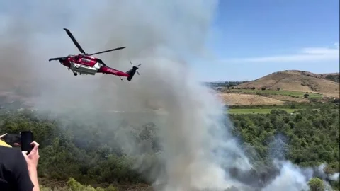 US: Fast-Moving Brush Fire Ignites Near Homes In California Contained Wit... Stock Footage 333718642