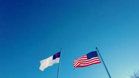 US flag and Christian Flag are waving in the wind on side by side poles. Stock Footage 144360478