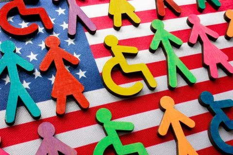 US flag and multi-colored figures with the symbol of a disability person. Stock Photos