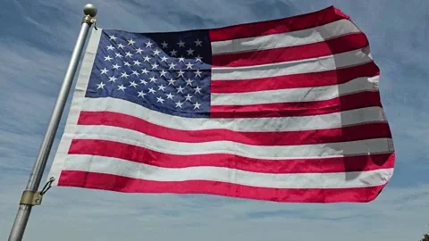 US Flag on Blue Sky Normal Speed Stock Footage 304636040