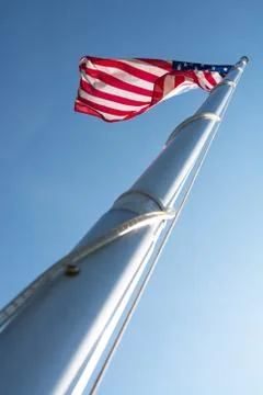 The US flag in blue sky Stock Photos