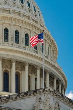 Us flag on capitol dome. Capitol with american flag near government building. Stock Photos