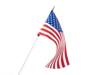 The U.S. flag is developing in the wind against a dark background. Isolate Photos