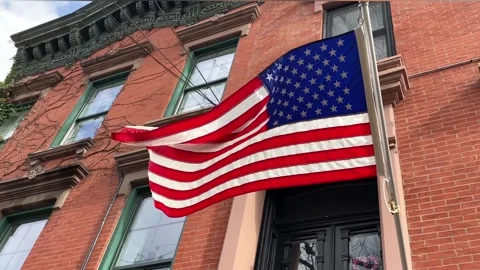 The US flag develops on the facade of a residential building Video stock 261575409