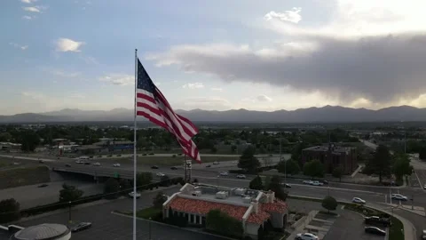 US Flag flowing in the wind in the middle of a city Stock Footage 154418626
