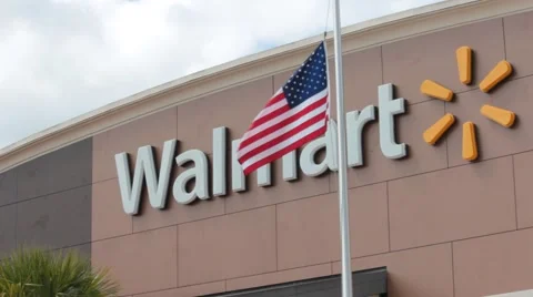 US Flag in Foreground of Walmart Store Stock Footage