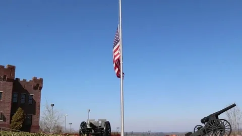 US Flag at Half Mast with Canons at Base Stock Footage 69223499