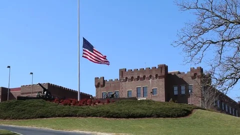 US Flag at Half Mast on Hillside Military Building Stock Footage 69222602