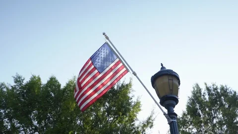 US Flag on Lamp Post-Push Past-Normal Speed-4K Stock Footage 91610301