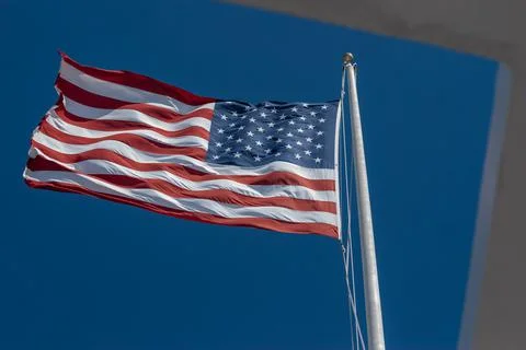 US flag as seen through open roof of the USS Arizona Memorial at Pearl Harbor Stock Photos
