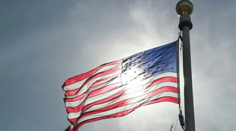 US Flag with the Sun shining through Stock Footage 7903091