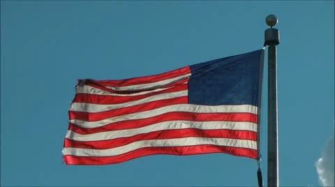 US flag waves - backlight by Sun Video stock 11674313