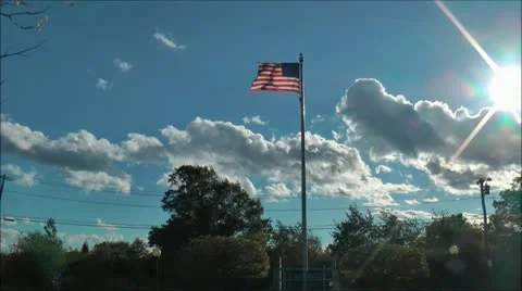 US flag waves with clouds and Sunshine Video stock 11674282