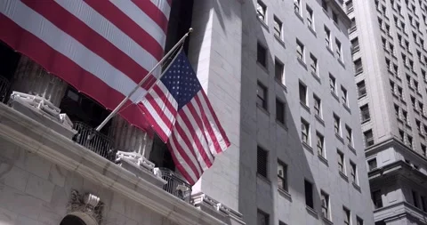 US flag waves at stock exchange, new york city, manhattan - 4K Stock Footage 207796445