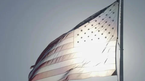 US flag waving with sunlight through Stock Footage 336671874